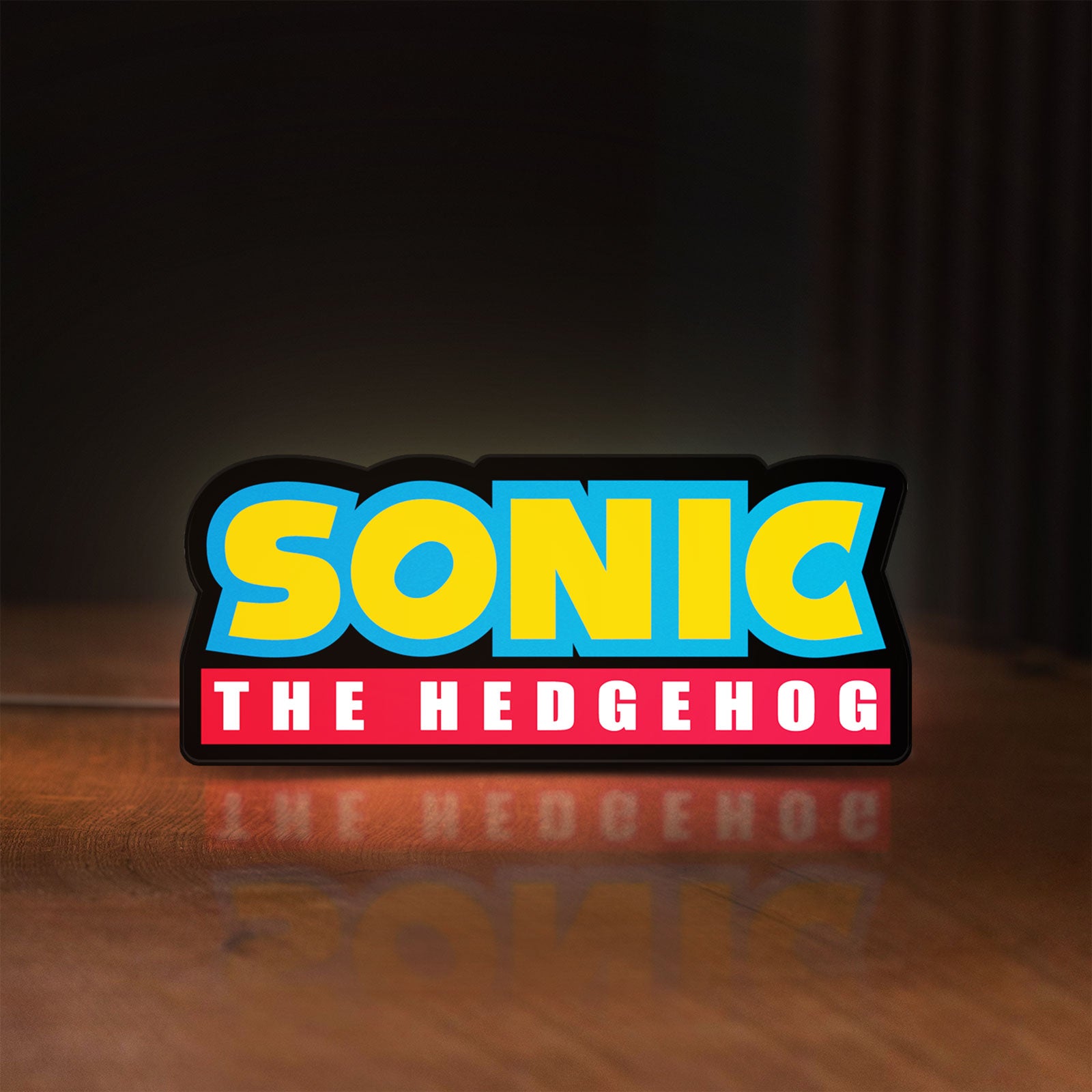 Front view of Sonic the Hedgehog LED lightbox sign glowing on a wooden desk