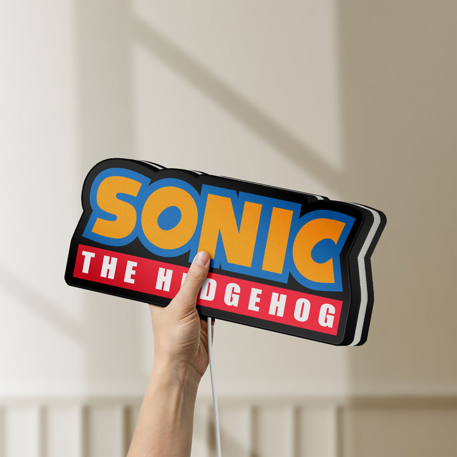 Unlit Sonic the Hedgehog LED lightbox held by hand to show size and details
