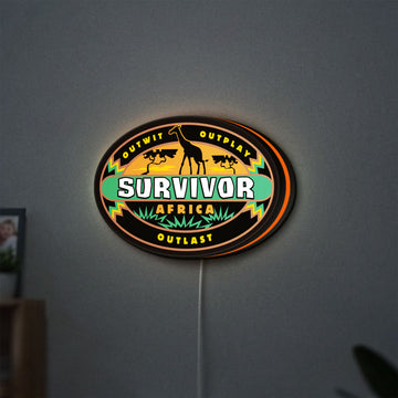 Survivor Africa LED lightbox hanging on a wall with orange glow