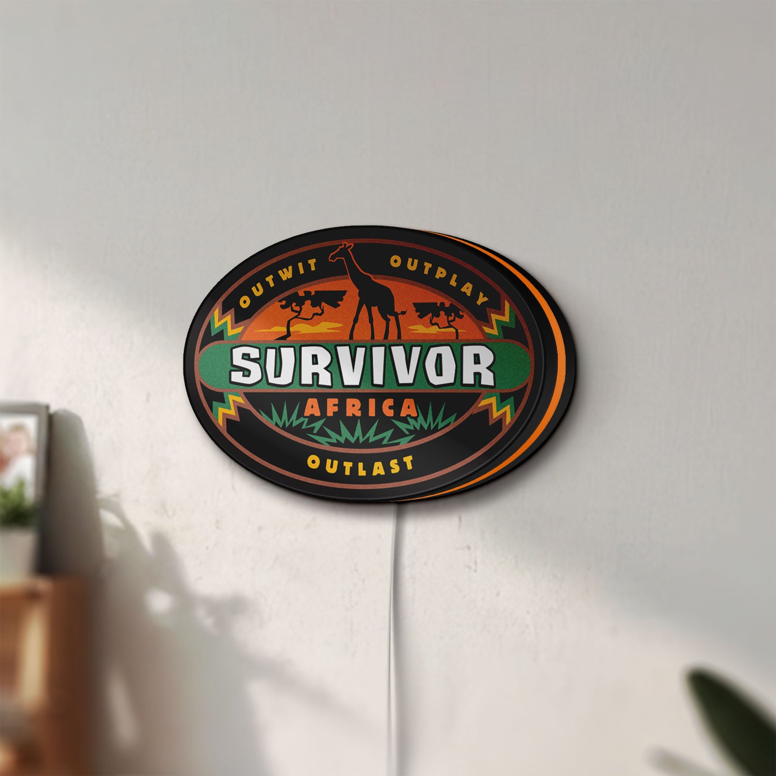 Unlit Survivor Africa LED lightbox mounted on a wall in daylight