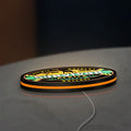 Survivor Africa LED lightbox lying flat on a desk with orange glow