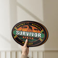Unlit Survivor Africa LED lightbox held by hand to show size and details