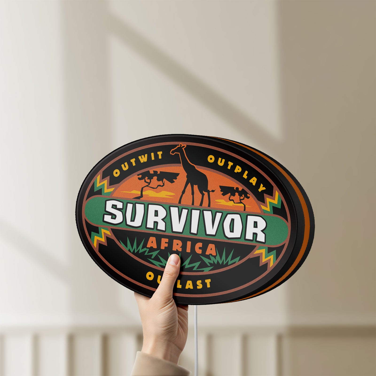 Unlit Survivor Africa LED lightbox held by hand to show size and details