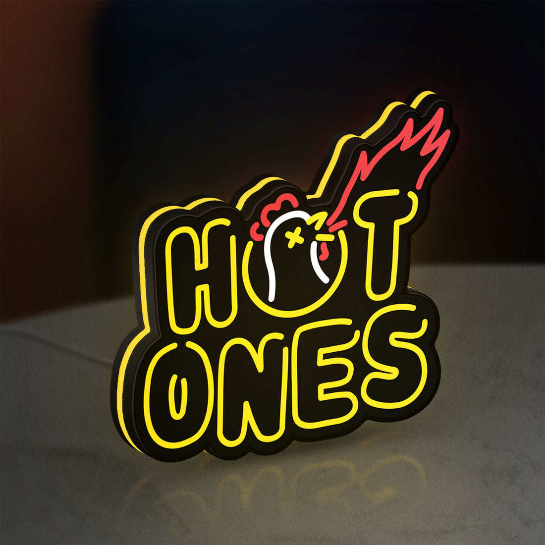 Hot Ones LED lightbox hanging on a wall with yellow glow