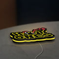 Hot Ones LED lightbox lying flat on a desk with yellow glow