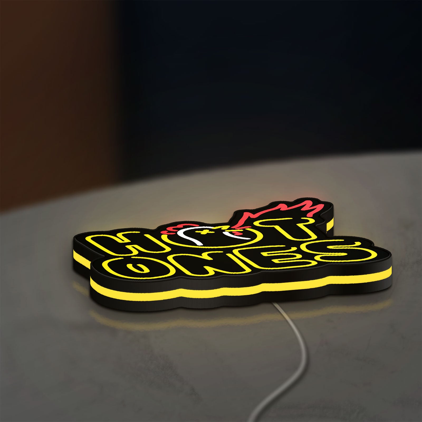 Hot Ones LED lightbox lying flat on a desk with yellow glow