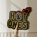 Unlit Hot Ones LED lightbox held by hand to show size and details