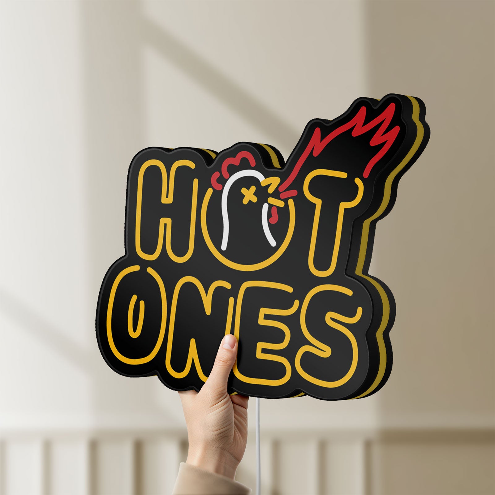 Unlit Hot Ones LED lightbox held by hand to show size and details