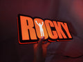Illuminated handheld size reference of Rocky Balboa 3D LED Sign in 40cm, perfect for music studio and bedroom decor