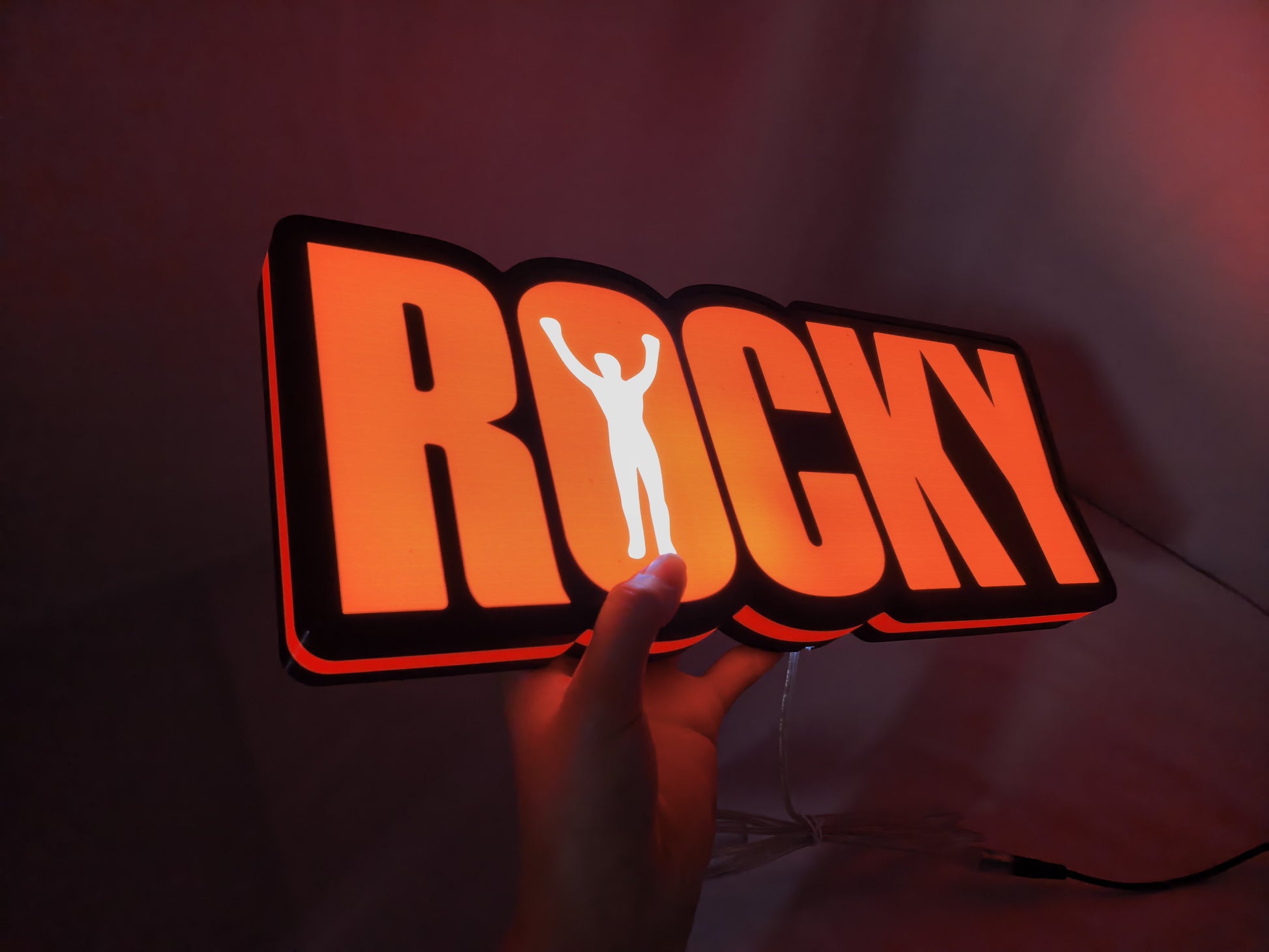 Illuminated handheld size reference of Rocky Balboa 3D LED Sign in 40cm, perfect for music studio and bedroom decor