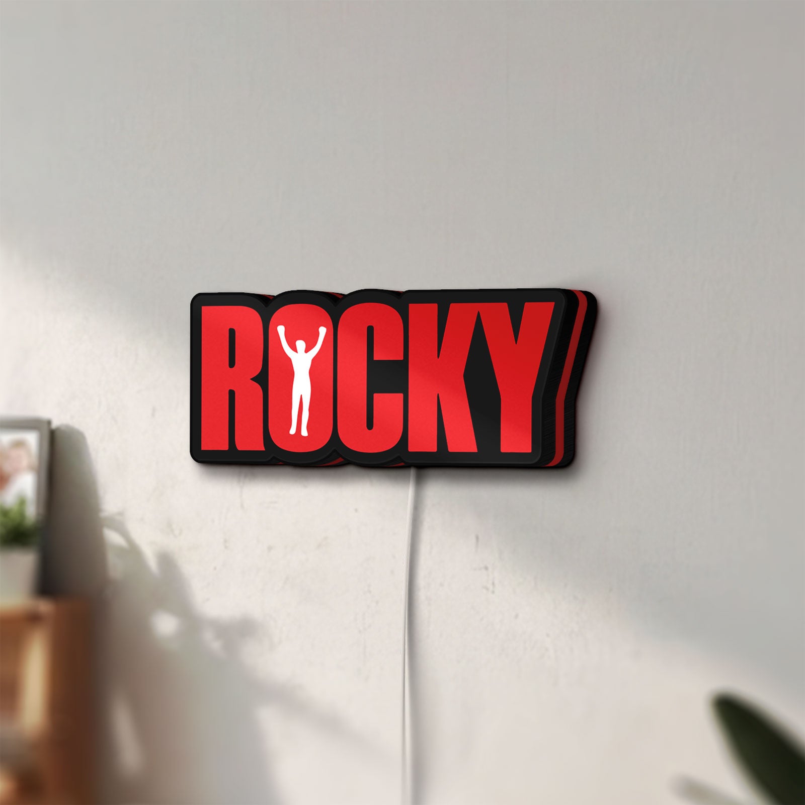 Unlit Rocky Balboa LED lightbox mounted on a wall in daylight