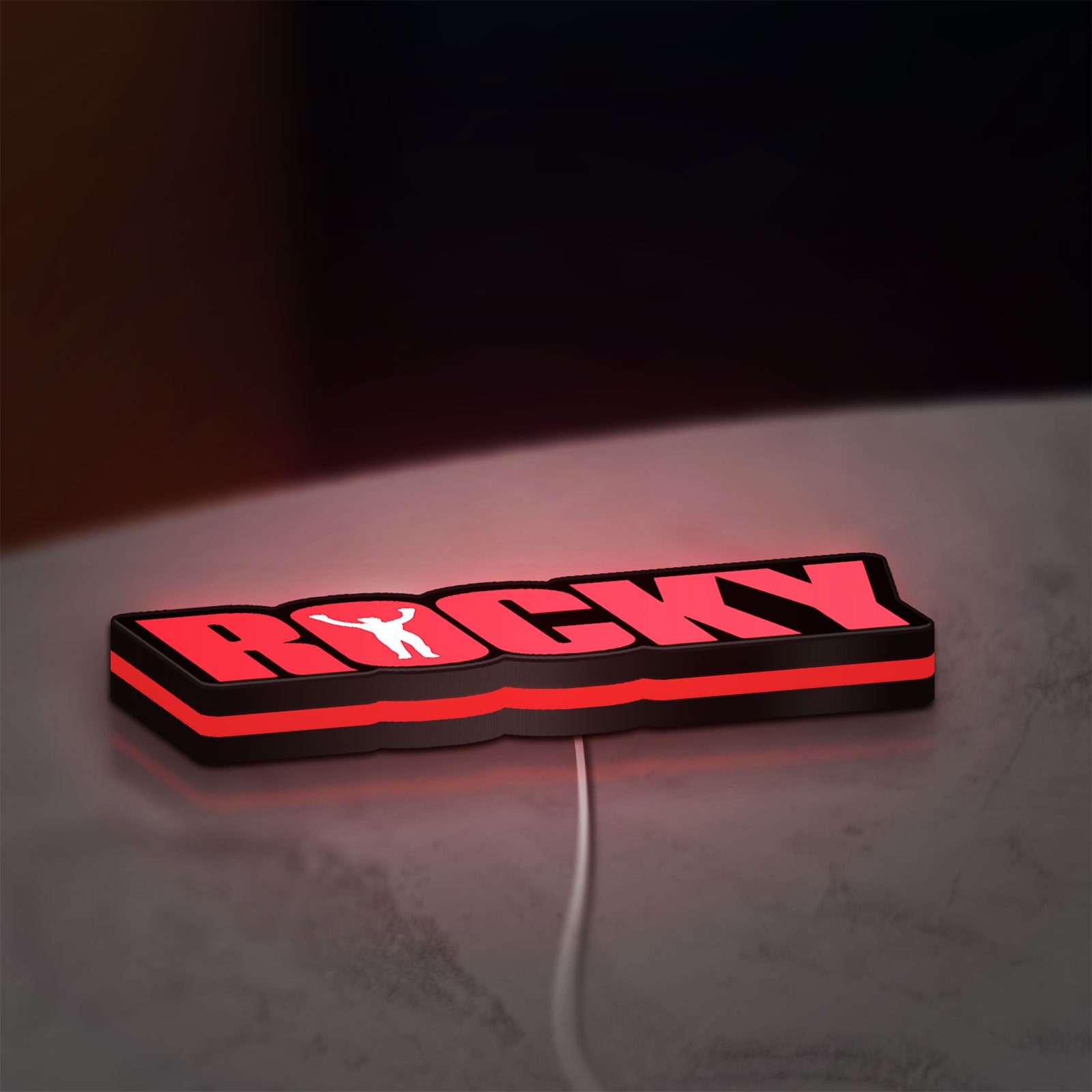 Rocky Balboa LED lightbox lying flat on a desk with red glow