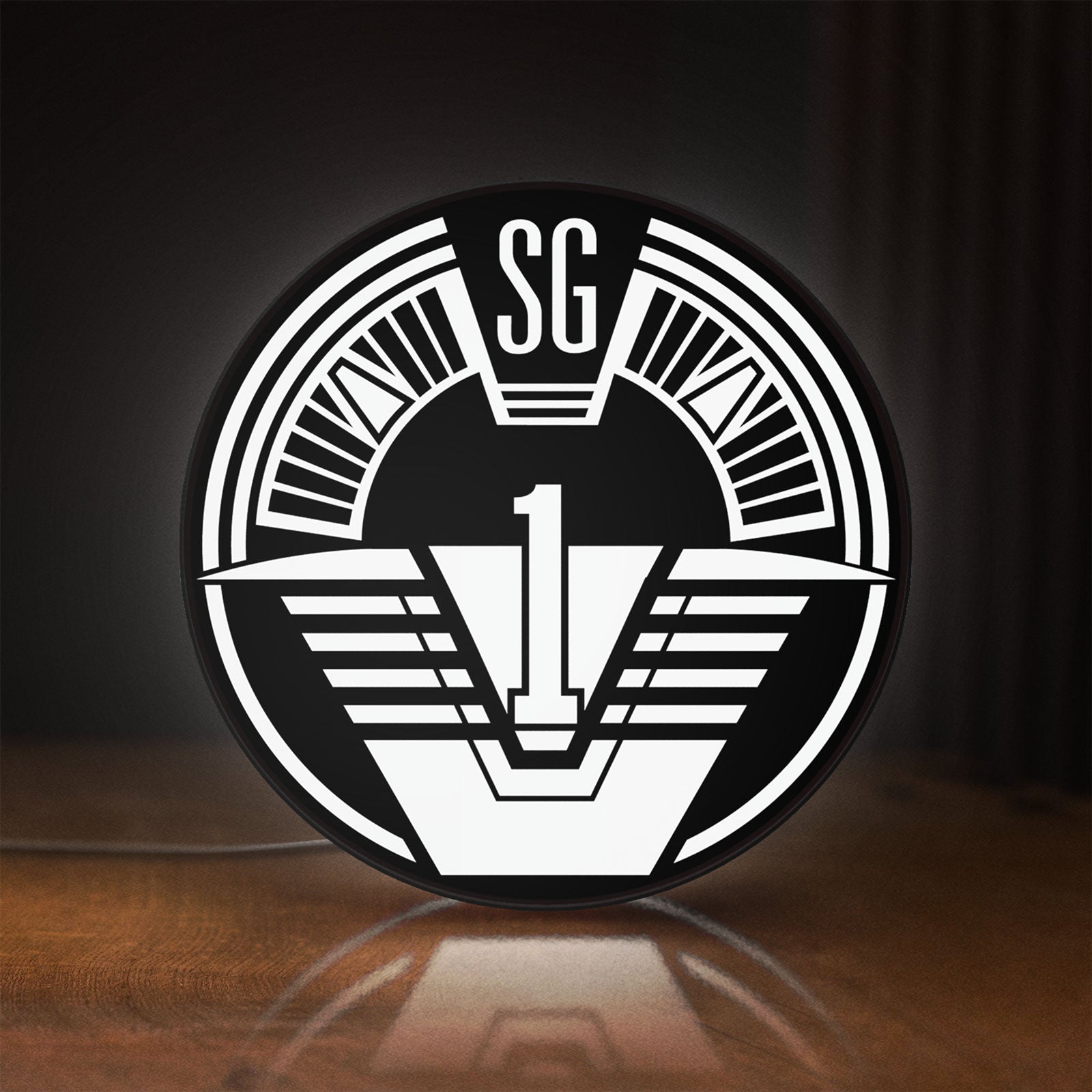Front view of SG-1 Patch Lightbox LED lightbox sign glowing on a wooden desk
