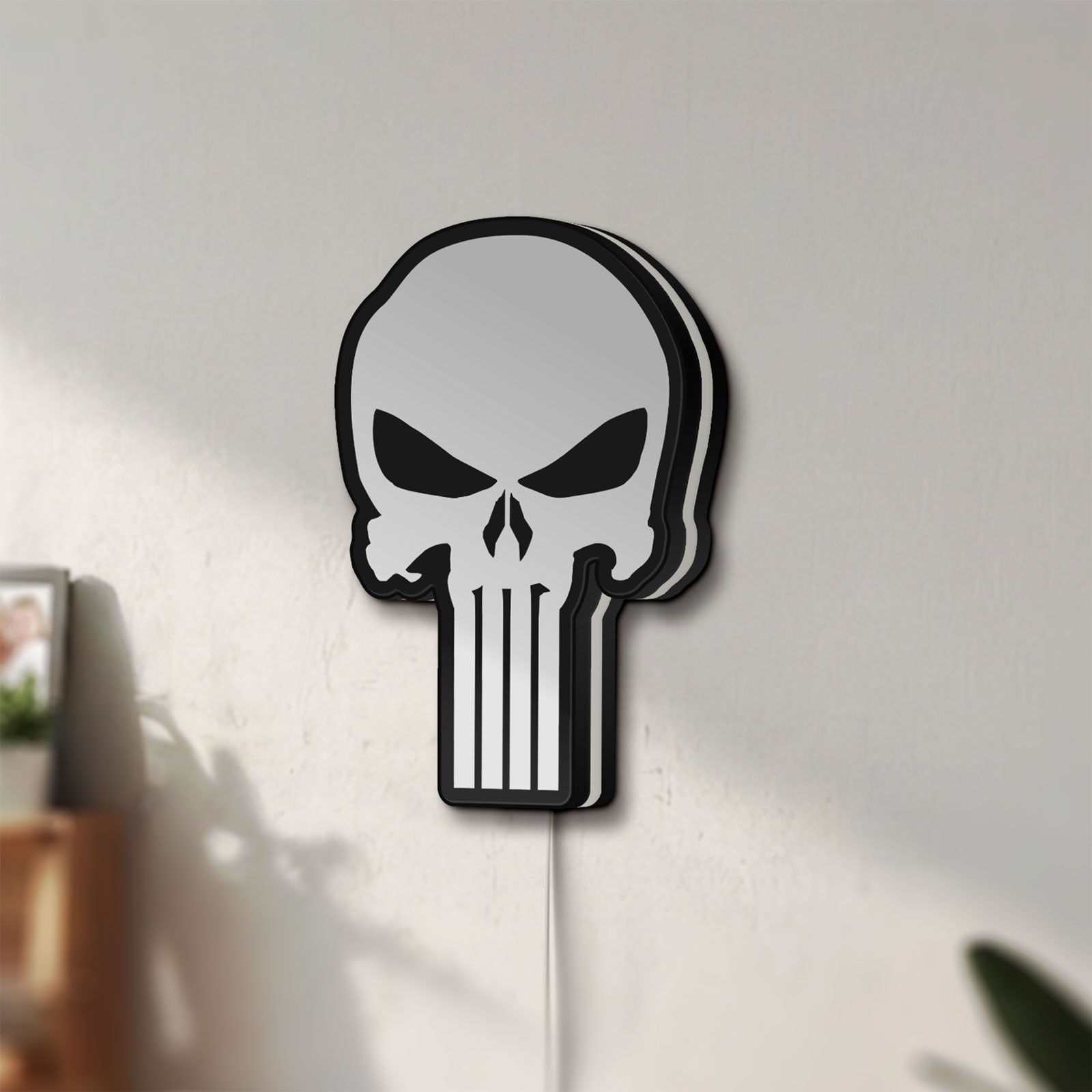 Unlit Punisher Skull LED lightbox mounted on a wall in daylight