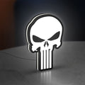 Punisher Skull LED lightbox standing on a desk from an angled side view with white glow