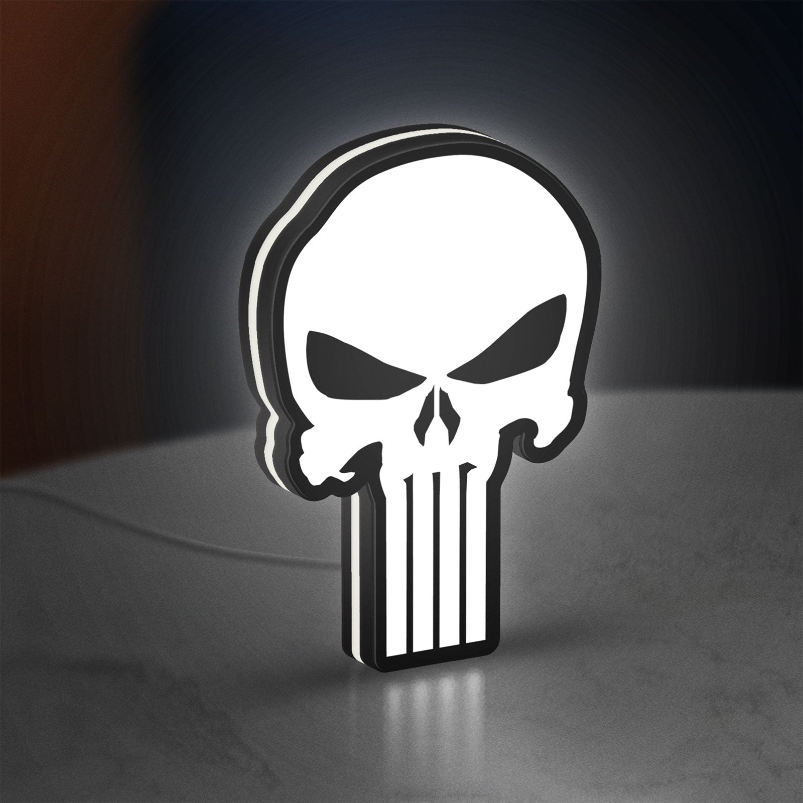 Punisher Skull LED lightbox standing on a desk from an angled side view with white glow