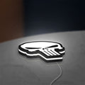 Punisher Skull LED lightbox lying flat on a desk with white glow