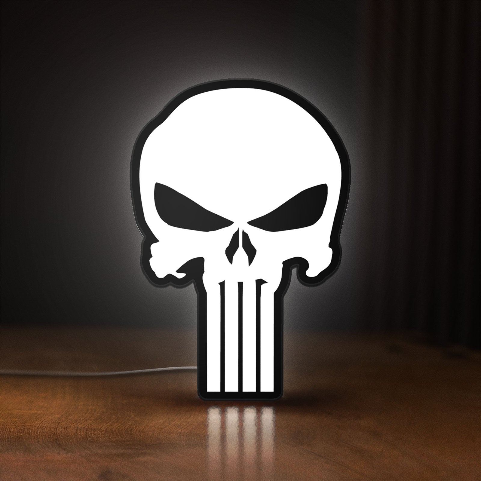 Front view of Punisher Skull LED lightbox sign glowing on a wooden desk