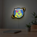 Discovery Kids Space LED lightbox hanging on a room wall with soft yellow light