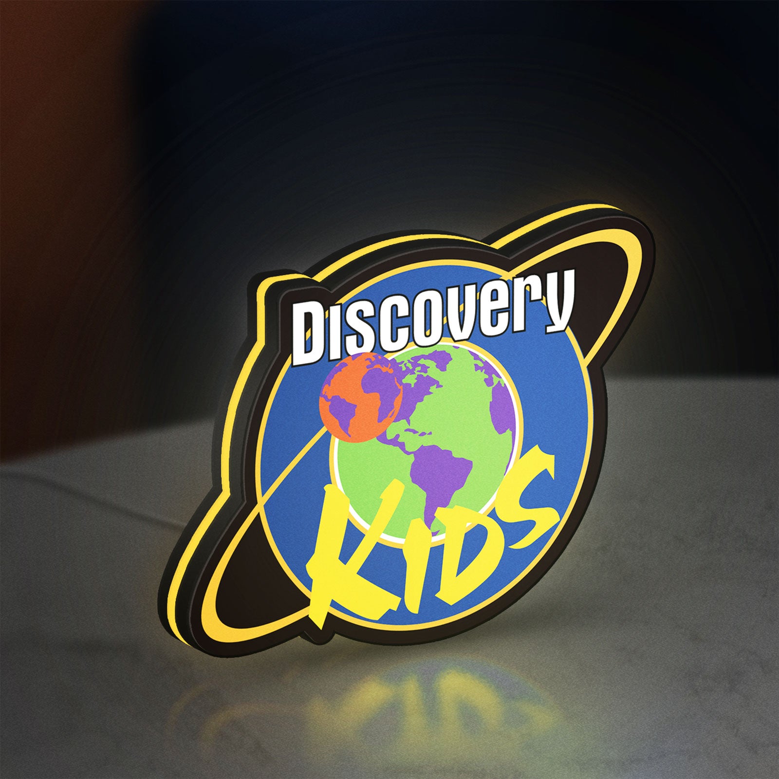 Discovery Kids Space LED lightbox standing on a desk from an angled side view with yellow glow
