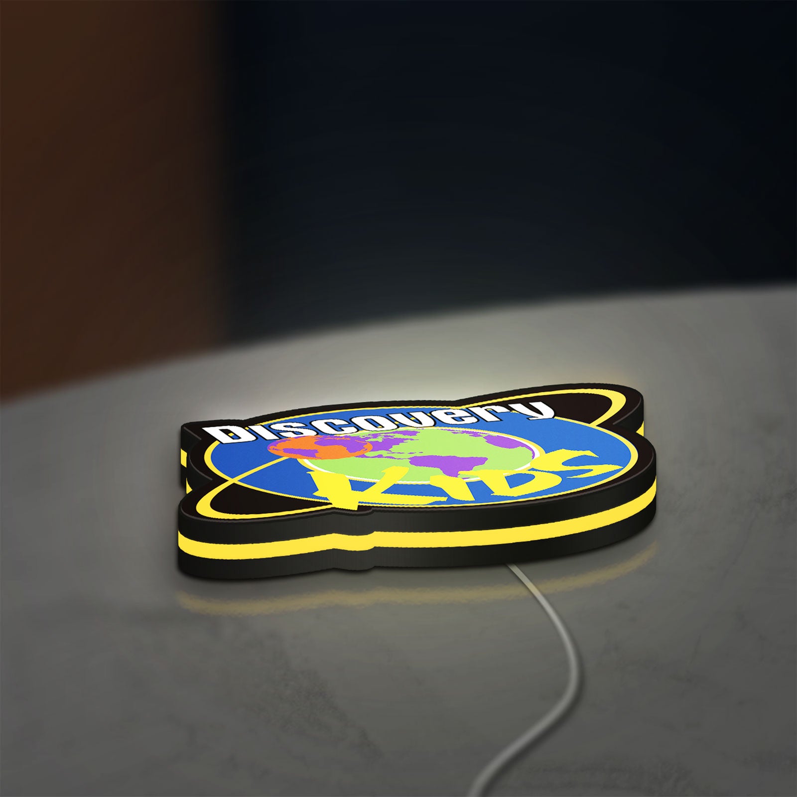 Discovery Kids Space LED lightbox lying flat on a desk with yellow glow