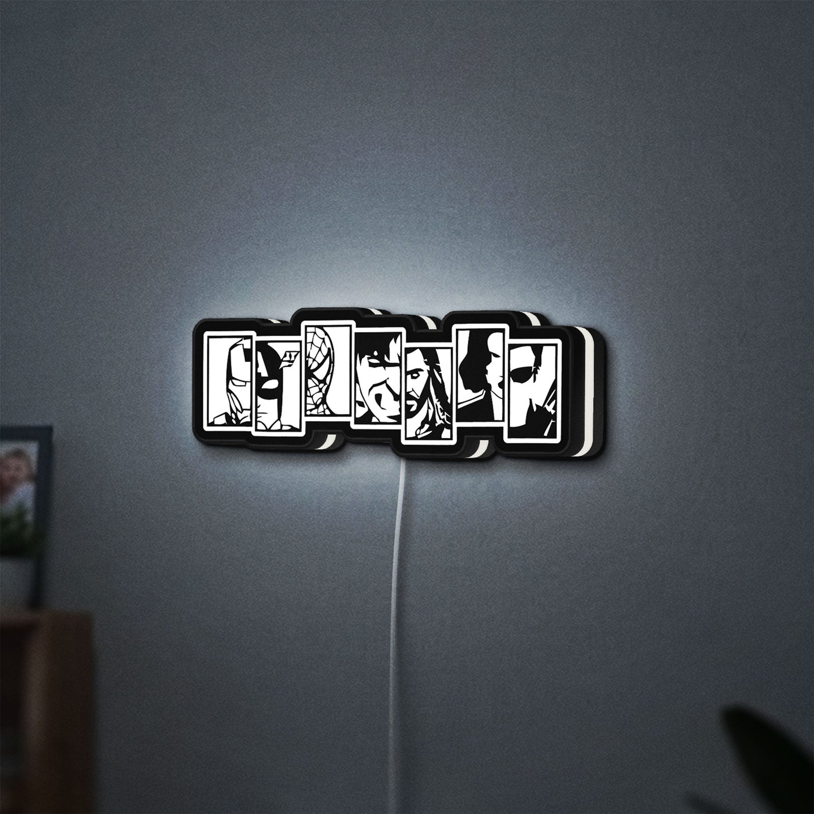 Avengers LED lightbox hanging on a wall with white glow