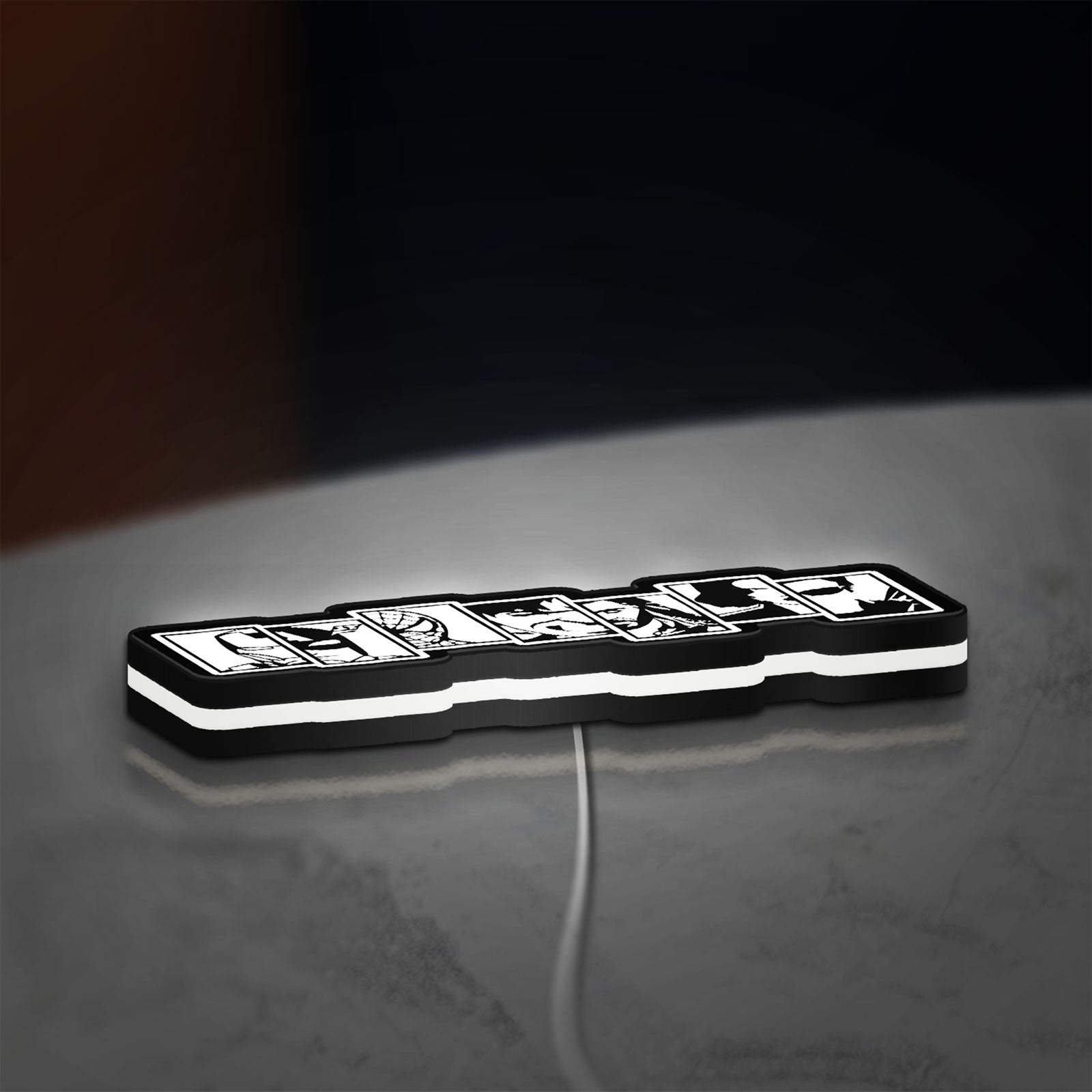 Avengers LED lightbox lying flat on a desk with white glow