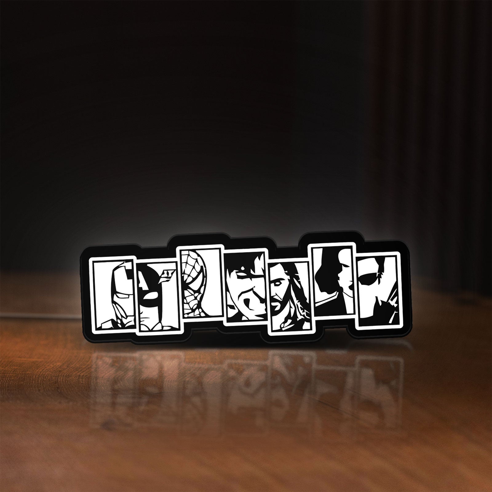 Front view of Avengers LED lightbox sign glowing on a wooden desk