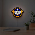 Top Gun Maverick LED lightbox hanging on a room wall with soft orange light
