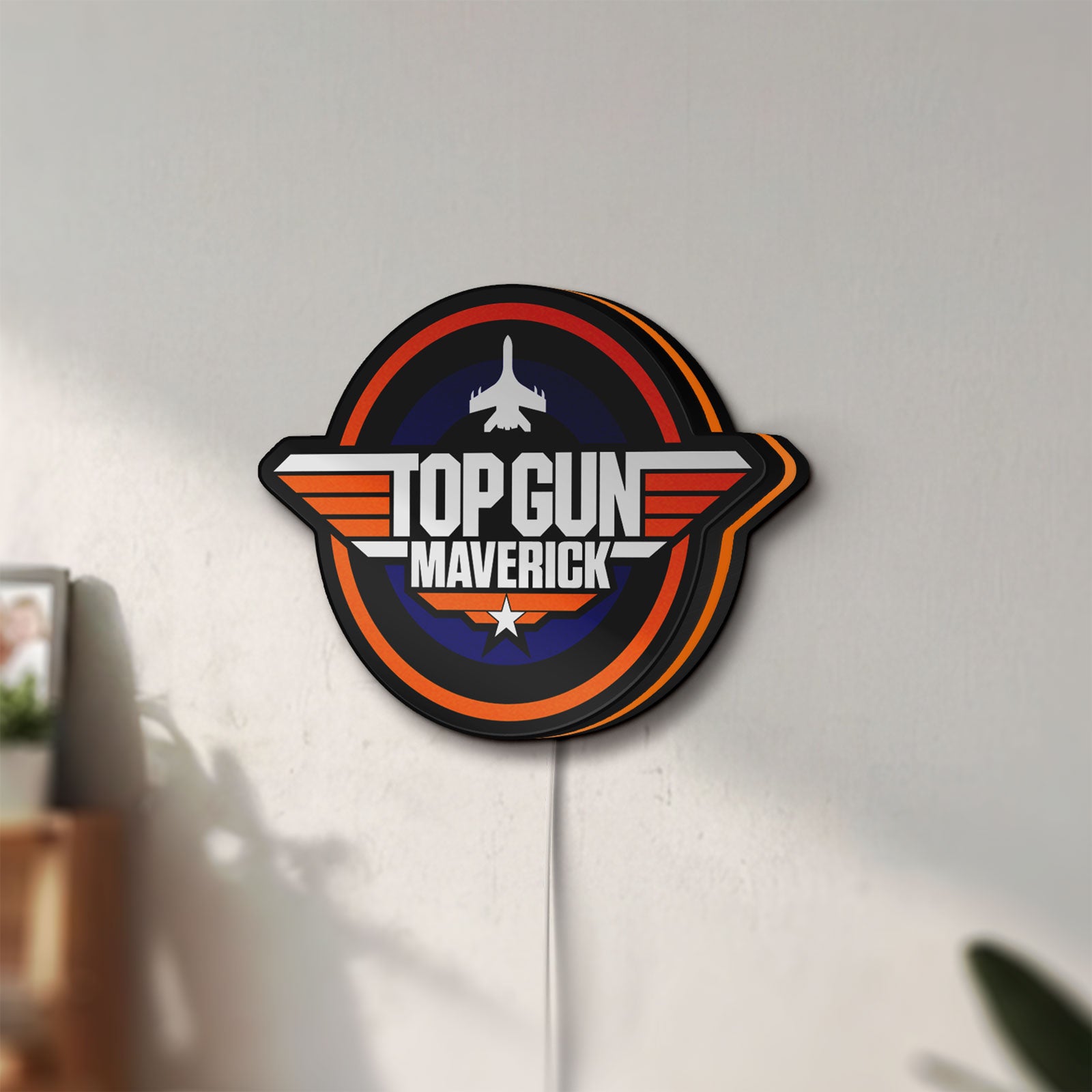 Unlit Top Gun Maverick LED lightbox mounted on a wall in daylight