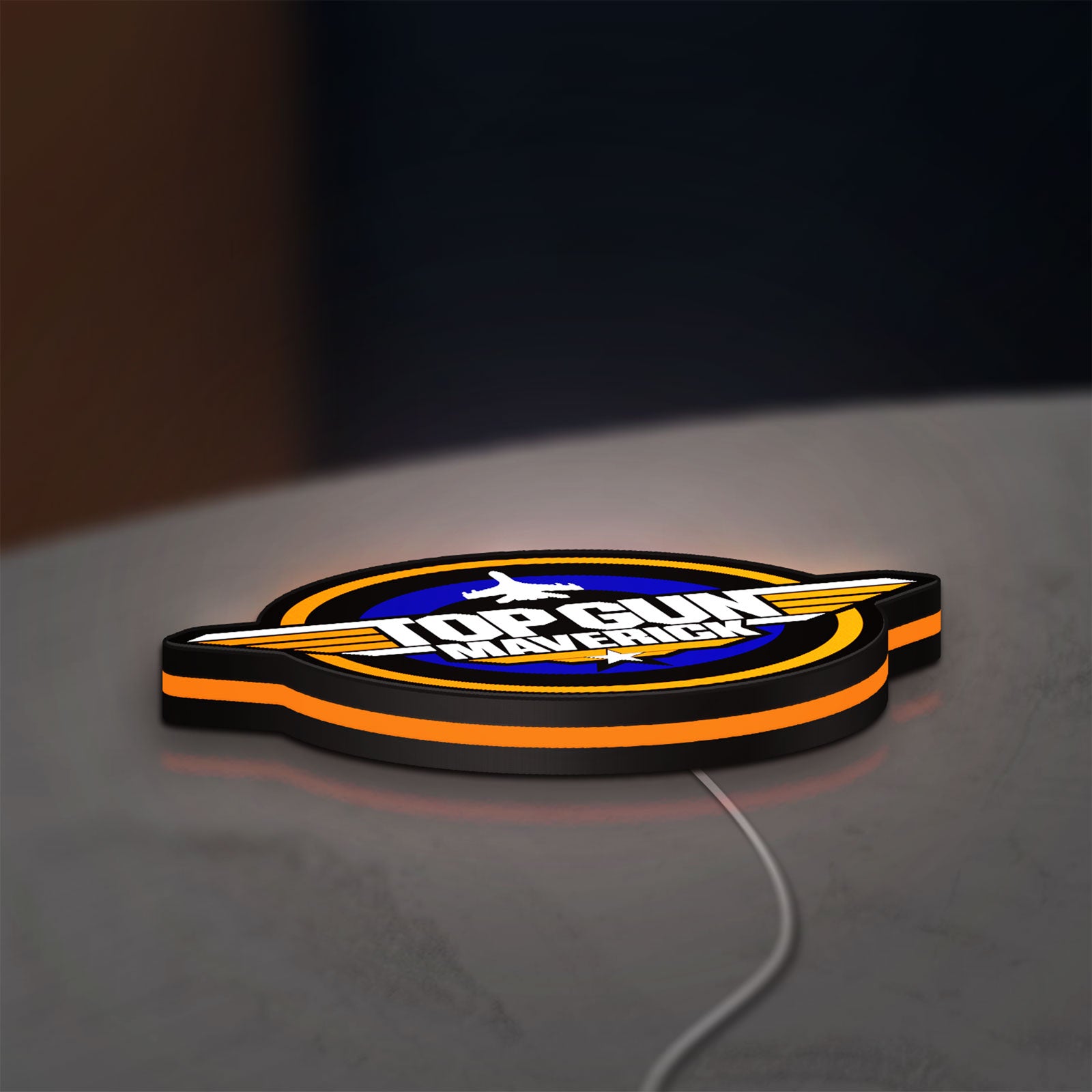 Top Gun Maverick LED lightbox lying flat on a desk with orange glow