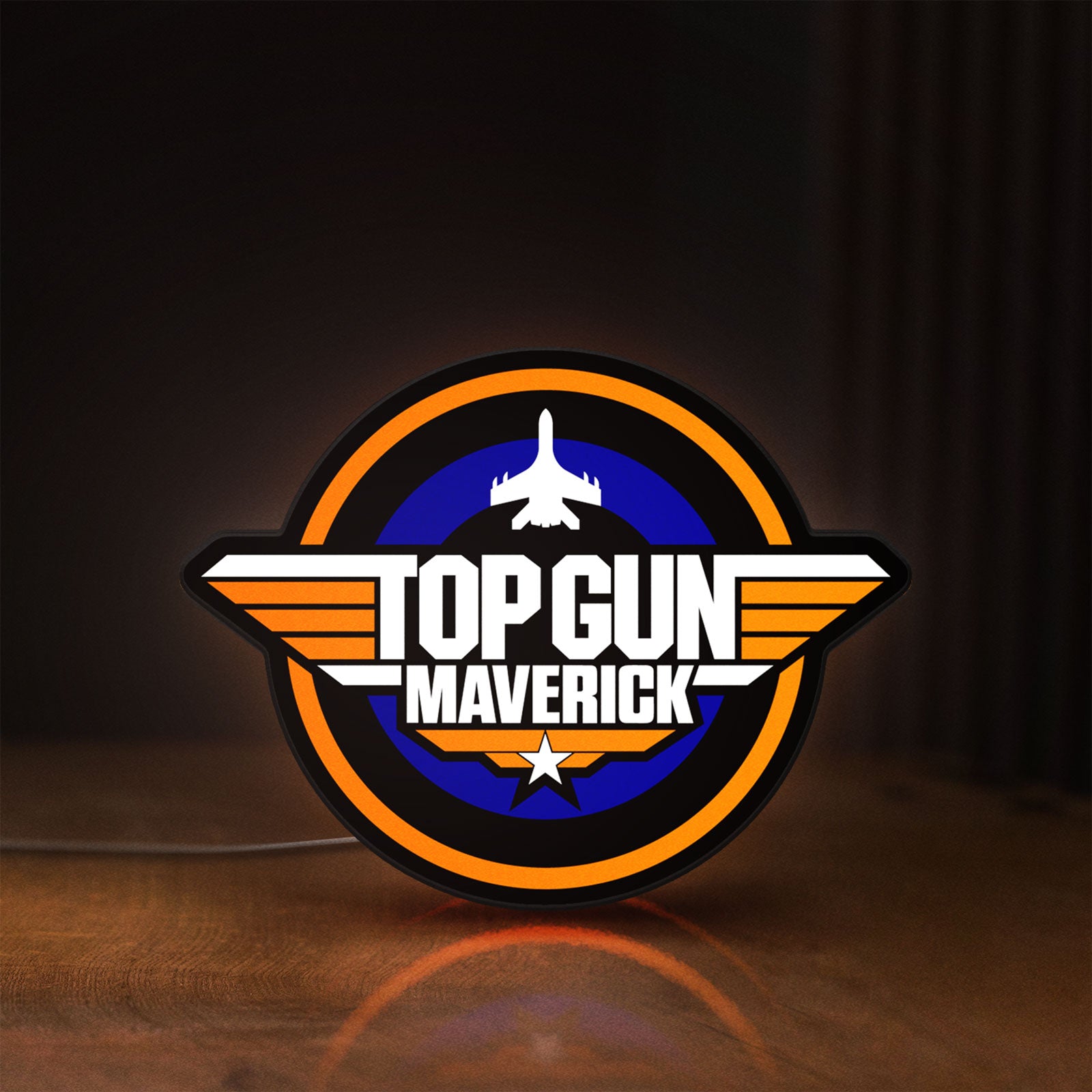 Front view of Top Gun Maverick LED lightbox sign glowing on a wooden desk