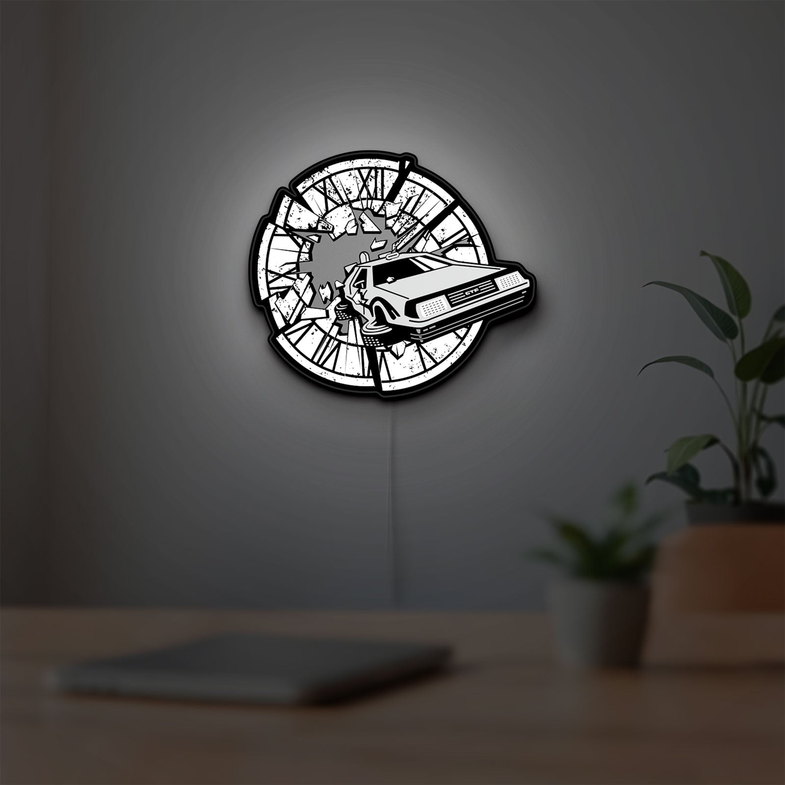 Back to the Future Delorean LED lightbox hanging on a room wall with soft white light