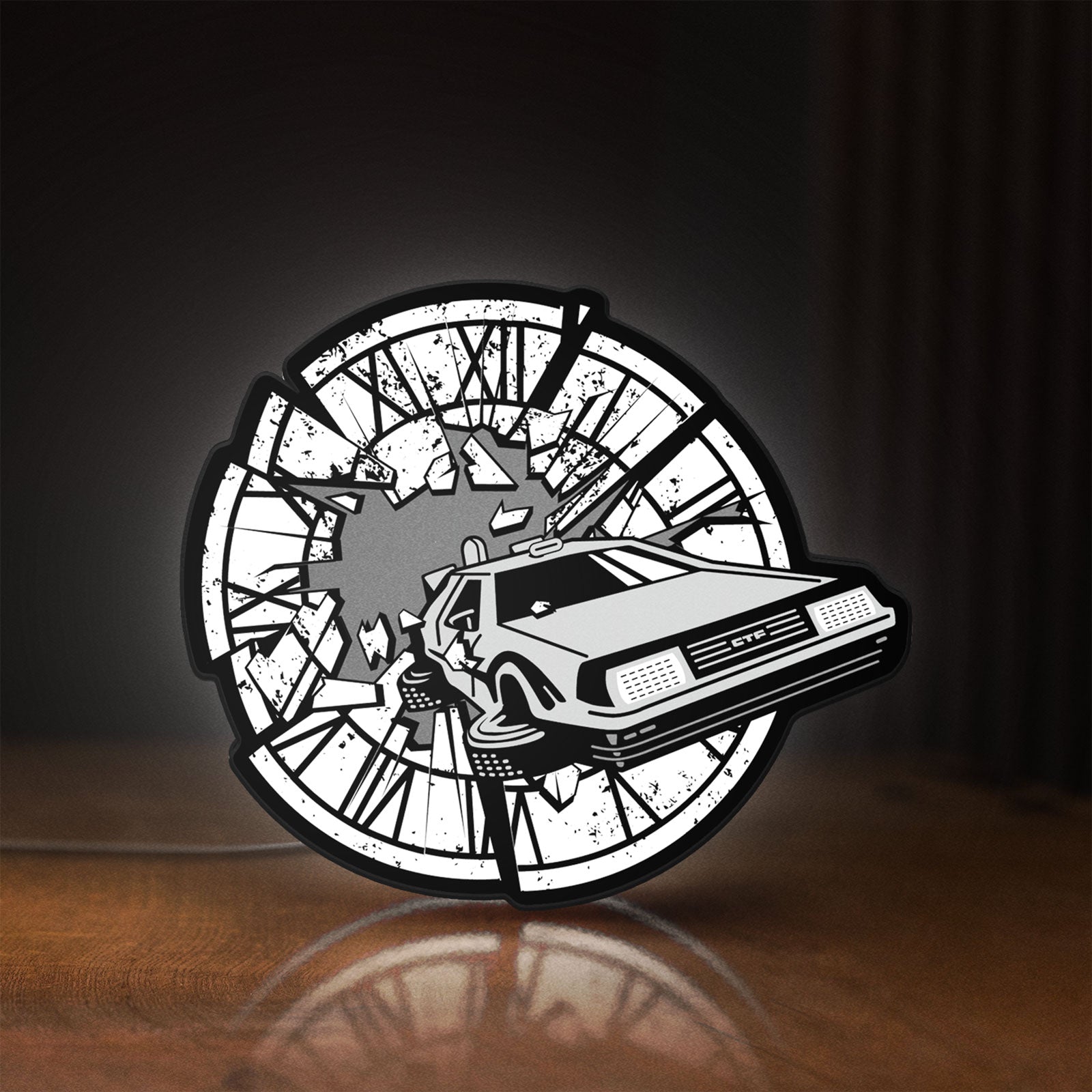 Front view of Back to the Future Delorean LED lightbox sign glowing on a wooden desk
