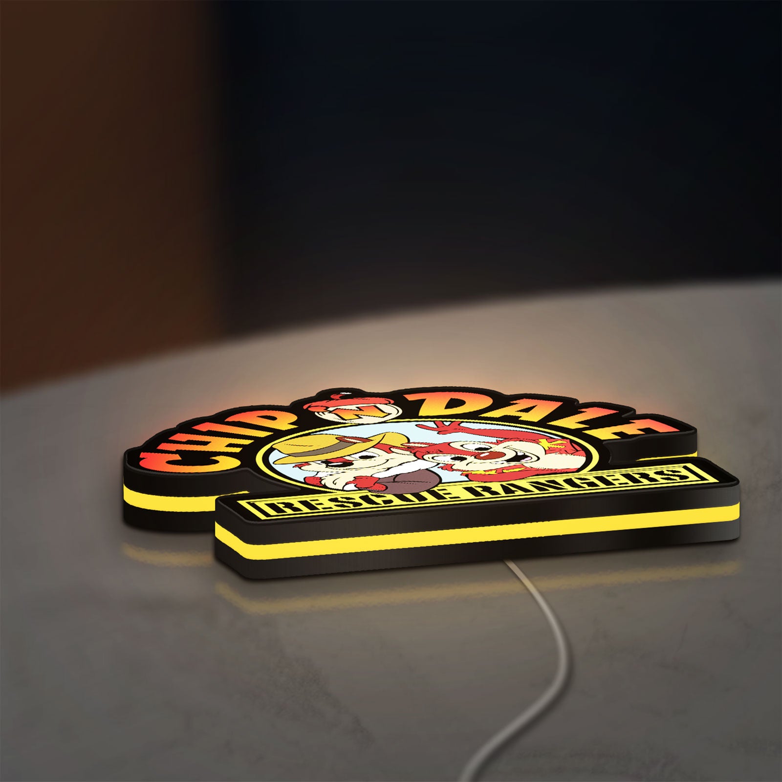 Chip n Dale Rescue Rangers LED lightbox lying flat on a desk with yellow glow