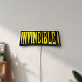 Unlit Invincible LED lightbox mounted on a wall in daylight