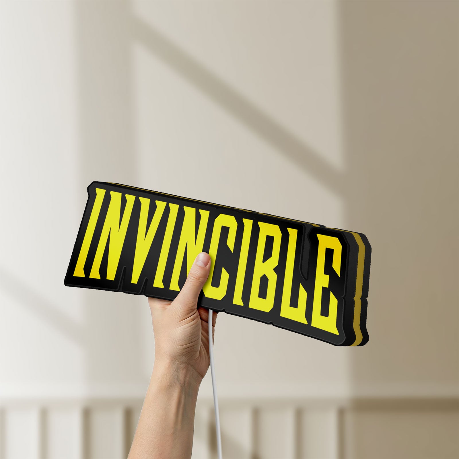 Unlit Invincible LED lightbox held by hand to show size and details