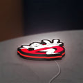 Ghostbusters LED lightbox lying flat on a desk with red glow