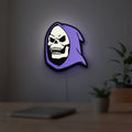 Skeletor LED lightbox hanging on a room wall with soft purple light