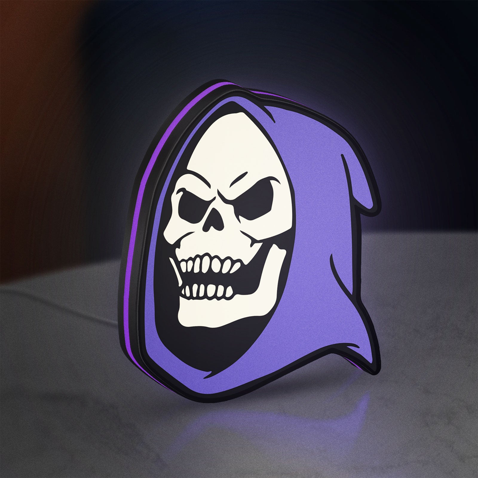 Skeletor LED lightbox standing on a desk from an angled side view with purple glow
