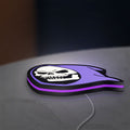 Skeletor LED lightbox lying flat on a desk with purple glow
