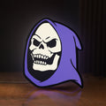 Front view of Skeletor LED lightbox sign glowing on a wooden desk
