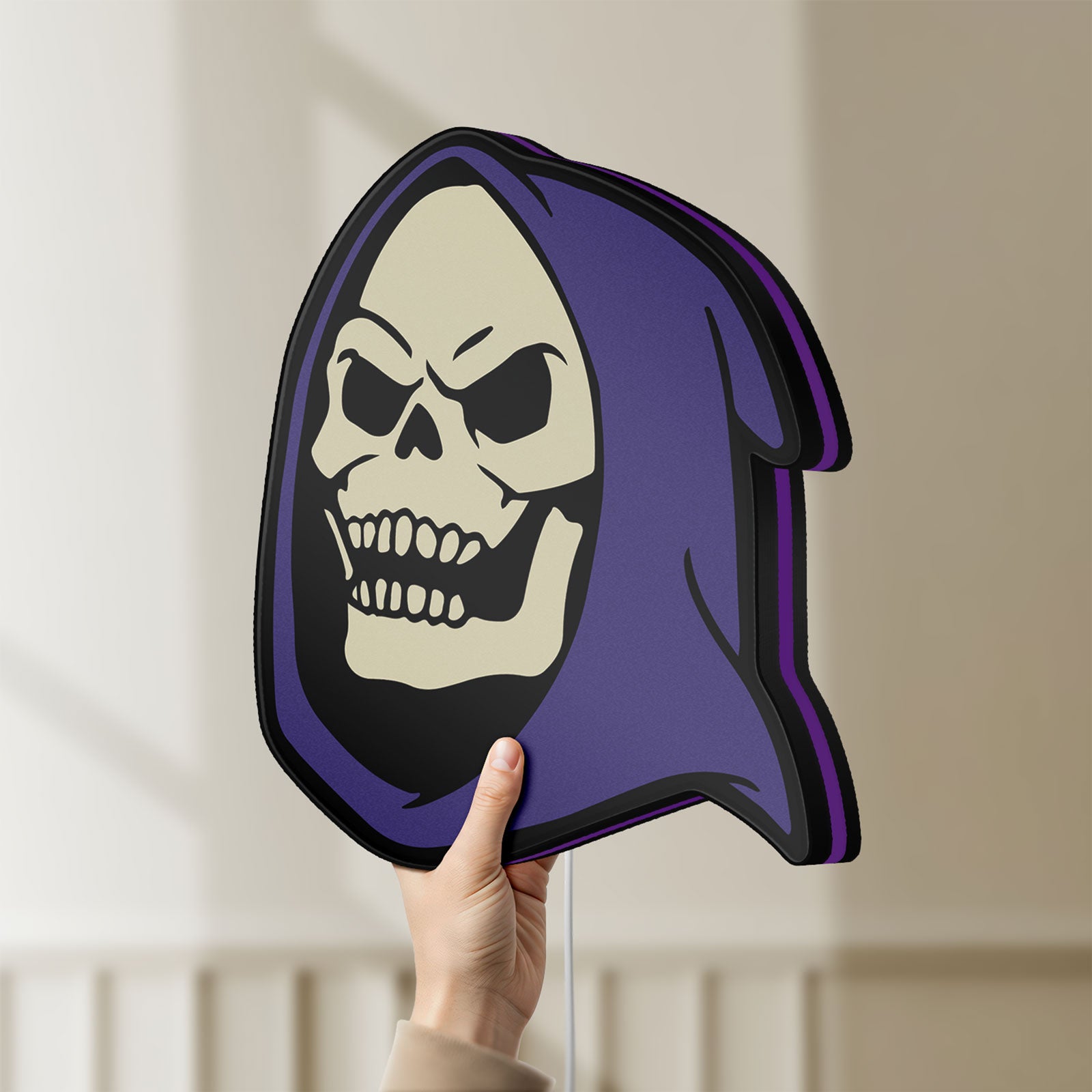 Unlit Skeletor LED lightbox held by hand to show size and details