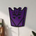 Unlit Decepticon LED lightbox mounted on a wall in daylight