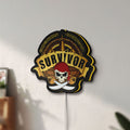 Unlit Expedition Robinson Survivor LED lightbox mounted on a wall in daylight