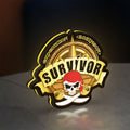 Expedition Robinson Survivor LED lightbox standing on a desk from an angled side view with yellow glow
