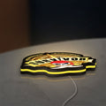 Expedition Robinson Survivor LED lightbox lying flat on a desk with yellow glow