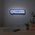 Yamaha LED lightbox hanging on a room wall with soft white light