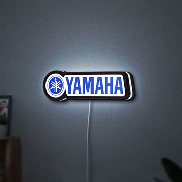 Yamaha LED lightbox hanging on a wall with white glow