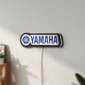 Unlit Yamaha LED lightbox mounted on a wall in daylight